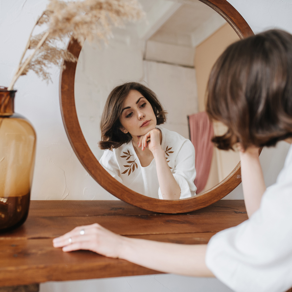 a person standing in front of a mirror posing for the camera